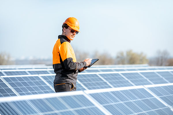 engineer servicing solar panel plant